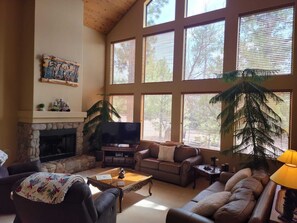 Floor to celling windows and a cozy fire place.