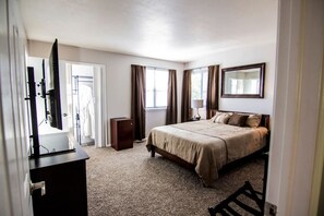 The main bedroom with a king-size bed and private full bathroom on the top floor