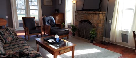 Beautiful living room featuring a limestone fireplace with new gas logs. 