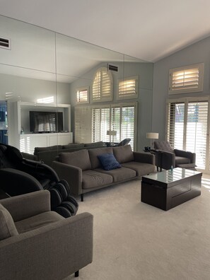 Living room with lots of seating and a large TV.