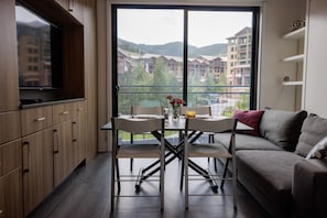 All furniture in the condo is purposefully designed. The tiny coffee table turns into a dining table as you see in this photo. This condo is available for monthly rentals. You’re welcome to come back for a longer stay.