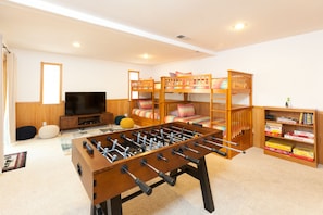 The ultimate kids room! Bunk beds, games, a TV and a foosball table