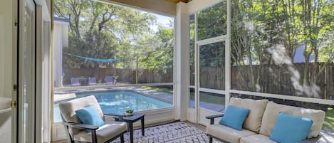 Large screened in porch is part of the outdoor living space.