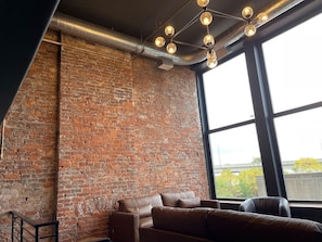 Floor to ceiling windows with natural exposed brick