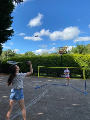 The side of the house can be used for games or parking. Ball stop nets provided.