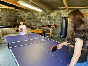 Full size table tennis in shed along with punch bag and kids'  foosball