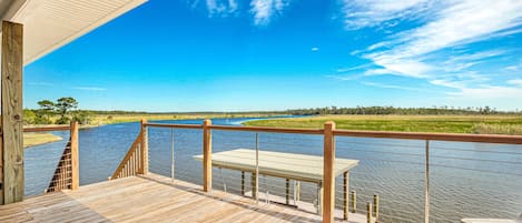 The front door of the house and deck overlooking Bayou Lacombe.