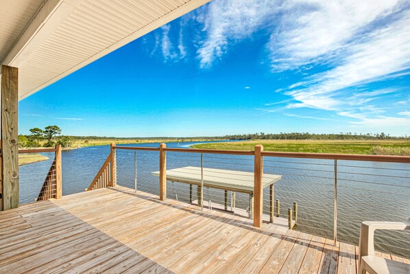 The front door of the house and deck overlooking Bayou Lacombe.