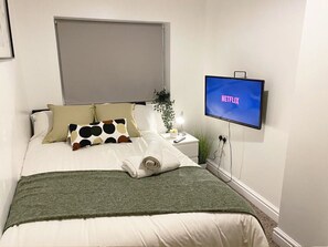 Team leaders bedroom with work desk and TV