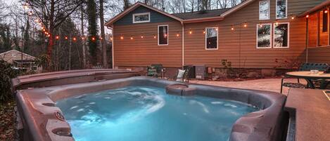 HOT TUB ON PATIO LIT UP AT NIGHT