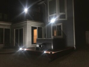 The sunroom and the hot tub next to it at night.