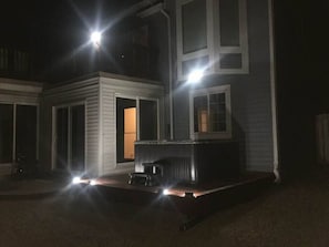 The sunroom and the hot tub next to it at night.