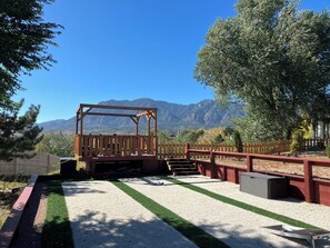 The backyard viewpoint of the Cheyenne Mountains with propane gas fire pit. 