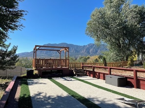 The backyard viewpoint of the Cheyenne Mountains with propane gas fire pit.