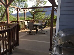 The large deck on the first floor with a propane gas BBQ grill