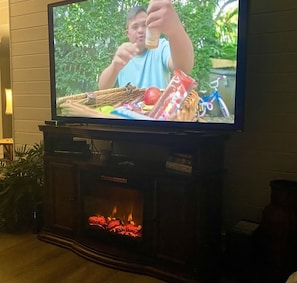 Huge TV with fireplace