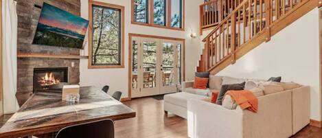 Great room with windowed high ceiling bringing the forest in.