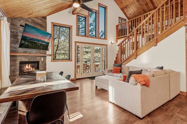 Great room with windowed high ceiling bringing the forest in.