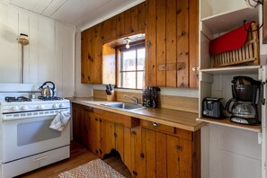 Kitchen includes stove/oven with full size refrigerator & all cooking utensils 