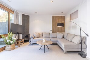 Large air-conditioned living room with a comfortable set of armchairs, a folding bed and TV. (2)