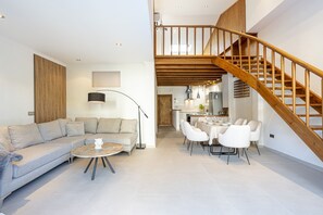 Large air-conditioned living room with a comfortable set of armchairs, a folding bed and TV. (1)