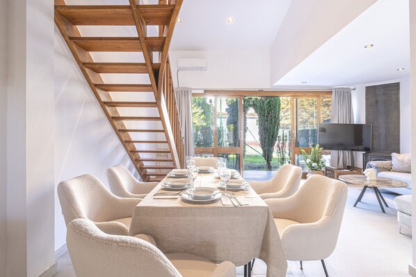 A table set for six people with comfortable soft chairs. (1)