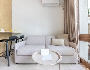 Living area: Table for two, comfy sofa, coffee table and air conditioning. (3)