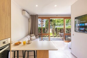 Living area: Table for two, comfy sofa, coffee table and air conditioning. (2)