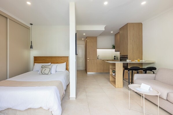 Living area: Table for two, comfy sofa, coffee table and air conditioning. (1)