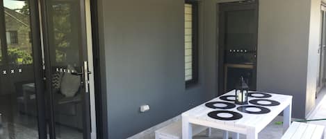 Large balcony with seating and BBQ area opening from kitchen and lounge area.