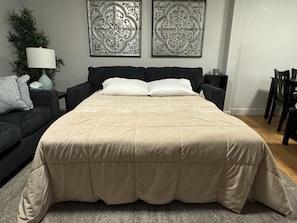 Pullout queen size memory foam mattress in living room.