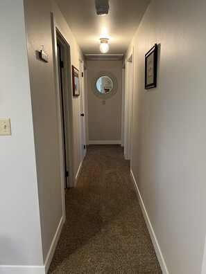 Hallway leading to bathrooms and bedrooms