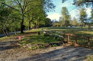 View from front porch, green space outside of fence available to guests.