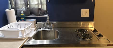 Kitchen area. Compact but room for prepping on counter.