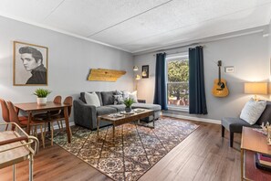 Bright and spacious living room off the kitchen. Smart TV, room darkening shades, and pull-out sleeper sofa for ultimate comfort + Dining table that can seat 4 people!