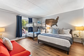 Comfortable King bed with plush bedding and a Queen over Queen Bunk bed in the bedroom. Room darkening curtains, closet to store your items and a couch for comfortable seating!