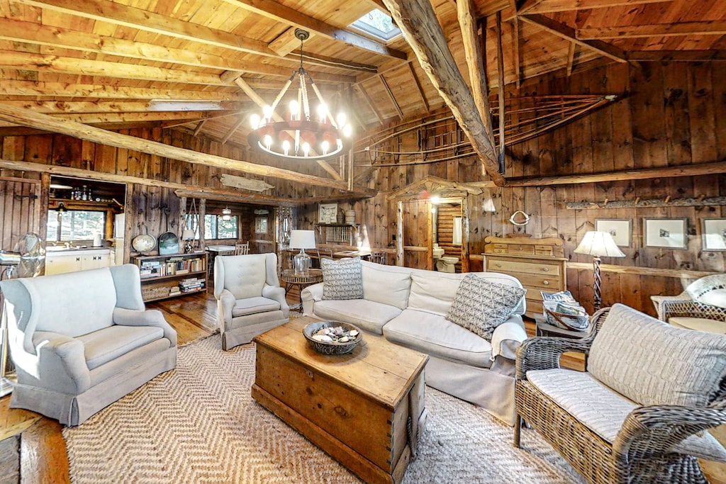 A traditional living room of a log cabin with high rafters and exposed beams