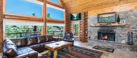 Living room features floor to ceiling windows.