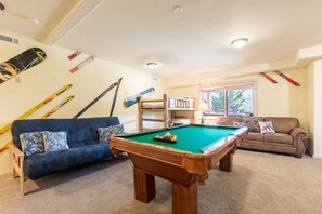 Game room offers a pool table, futon, and bunk bed.