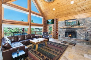 Living room features floor to ceiling windows. (Eagle Ridge Retreat)