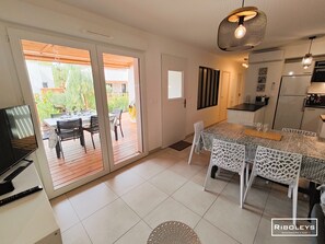 Air-conditioned living room opening onto terrace