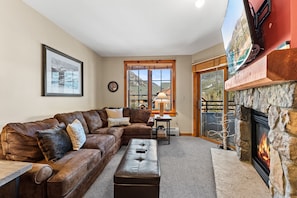 Living area featuring cozy furnishings, gas fireplace, and a mounted TV.