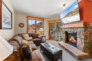 Living area featuring cozy furnishings, gas fireplace, and a mounted TV.