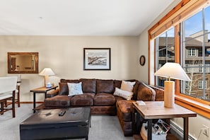 Living area featuring cozy furnishings, gas fireplace, and a mounted TV.