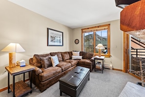 Living area featuring cozy furnishings, gas fireplace, and a mounted TV.