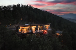 Zem Treejpise + Glamping Tent from the air at twilight with Mt. Rosalie in back.