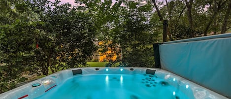 Enjoy sunset views while relaxing in our backyard hot tub.