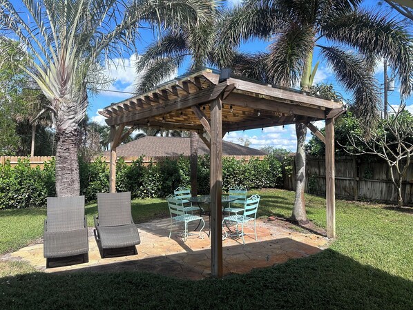 Relax with your morning coffee or a nightcap in this sunlit backyard.  