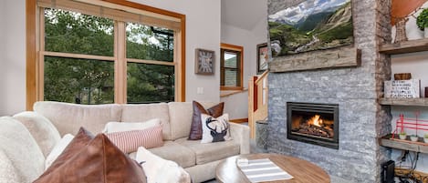 Cozy Living Room with plush sectional, gas fireplace, and 55" smart tv