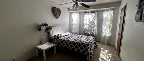 First bedroom with bay windows, private bath and walk in closet.